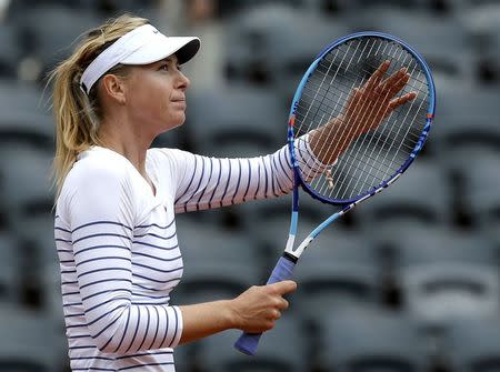 Maria Sharapova of Russia celebrates after beating compatriot Vitalia Diatchenko during their women's singles match at the French Open tennis tournament at the Roland Garros stadium in Paris, France, May 27, 2015. REUTERS/Gonzalo Fuentes