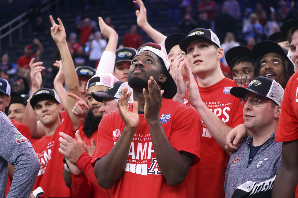 Arizona guard Courtney Ramey, center, celebrates alongside teammates after their win over UCLA in an NCAA college basketball game for the championship of the men's Pac-12 Tournament, Saturday, March 11, 2023, in Las Vegas. (AP Photo/Chase Stevens)