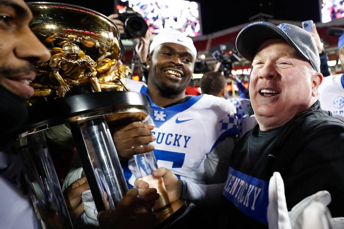 Kentucky Coach Mark Stoops and the Wildcats celebrated with the Governor’s Cup trophy after the Wildcats defeated the Louisville Cardinals 52-21 at Cardinal Stadium last season.