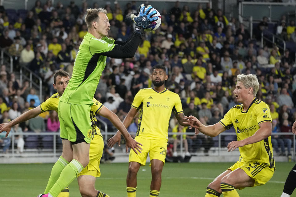 Nashville SC goalkeeper Joe Willis, front left, defends the goal during the first half of an MLS soccer match against the Columbus Crew, Sunday, May 28, 2023, in Nashville, Tenn. (AP Photo/George Walker IV)