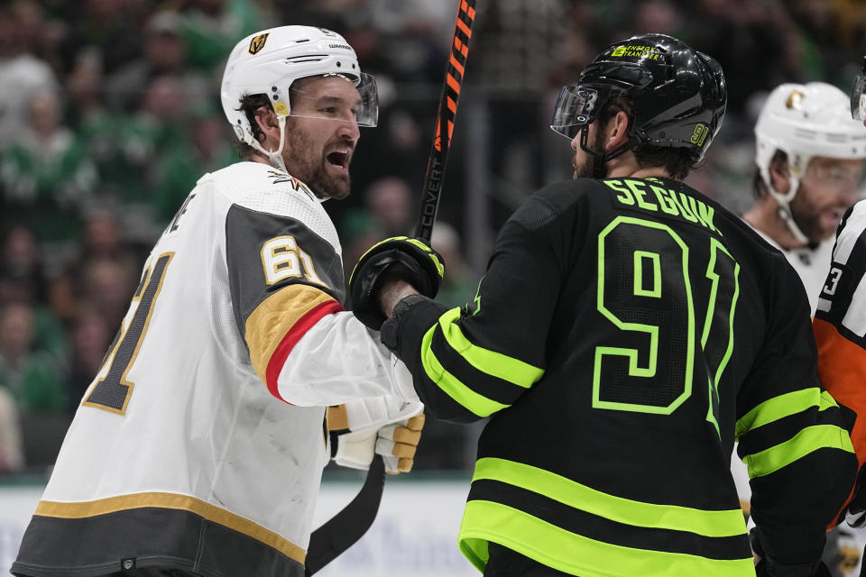Vegas Golden Knights right wing Mark Stone, left, and Dallas Stars center Tyler Seguin argue during the first period of an NHL hockey game, Wednesday, Nov. 22, 2023, in Dallas. (AP Photo/Tony Gutierrez)