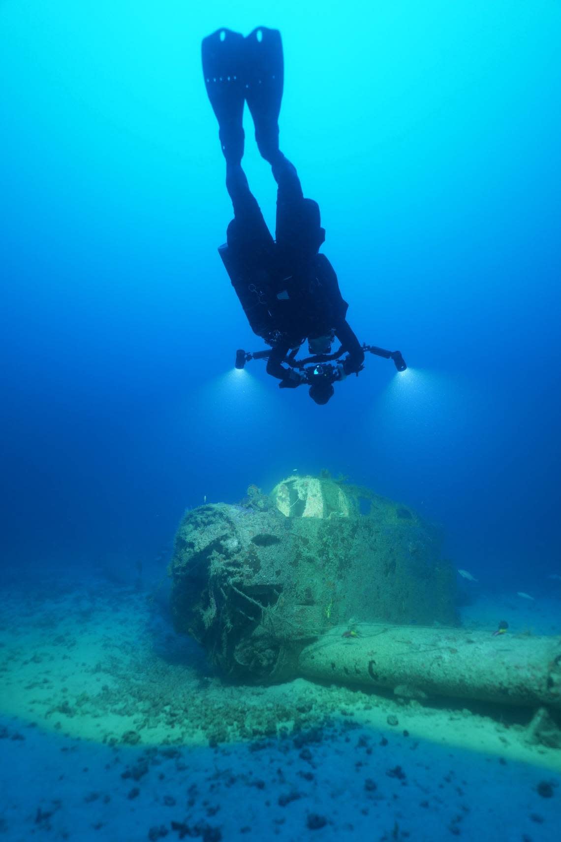 A diver swims above the wreckage of a U.S. Marine Corps Douglas AD-5 Skyraider plane sitting at the bottom of the ocean off Key Biscayne.