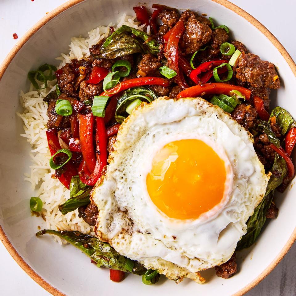 saucy, spicy, and slightly sweet ground beef tossed with peppers, fresh basil, garlic, and ginger served over white rice and topped with a runny fried egg