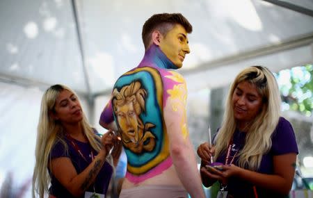 Artists paint a model during the "World Bodypainting Festival 2018" in Klagenfurt, Austria, July 13, 2018. REUTERS/Lisi Niesner