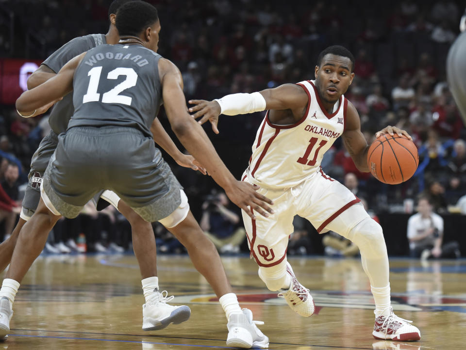 Oklahoma guard De'Vion Harmon (11) pushes past Mississippi State guard Robert Woodard (12) during the first half of an NCAA college basketball game in Oklahoma City, Saturday, Jan. 25, 2020. (AP Photo/Kyle Phillips)