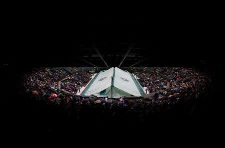 Britain Tennis - Wimbledon - All England Lawn Tennis & Croquet Club, Wimbledon, England - 2/7/16 General view of the cover over court 1 as rain delays play REUTERS/Stefan Wermuth