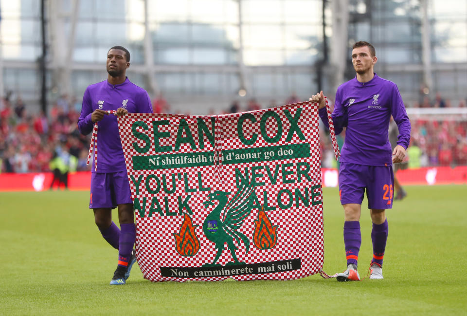 Liverpool’s Georginio Wijnaldum (left) and Andy Robertson hold a banner for Liverpool fan Sean Cox after the pre-season friendly match at the Aviva Stadium, Dublin.