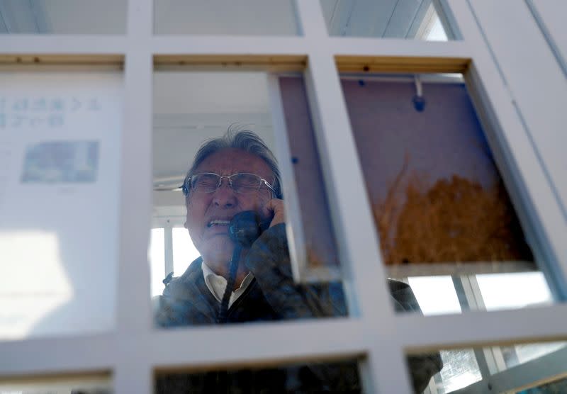 The Wider Image: Japan's tsunami survivors call lost loves on the phone of the wind