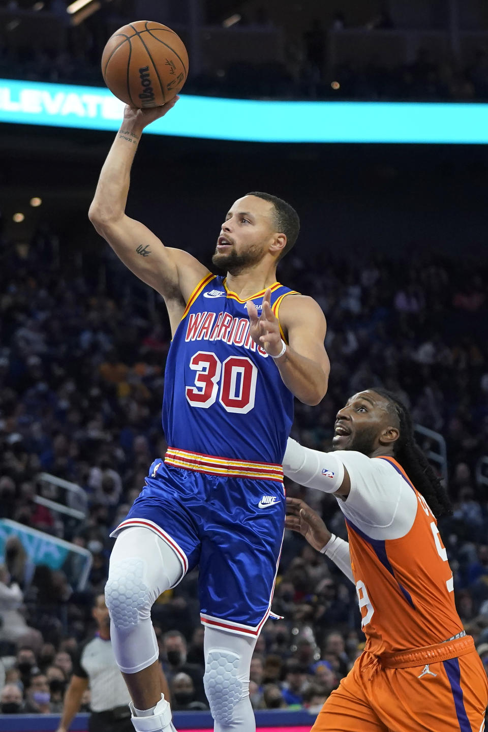 Golden State Warriors guard Stephen Curry (30) shoots against Phoenix Suns forward Jae Crowder during the second half of an NBA basketball game in San Francisco, Friday, Dec. 3, 2021. (AP Photo/Jeff Chiu)