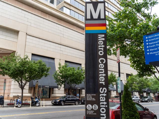 sign for a metro station in Washington DC — gray pole with M at the top