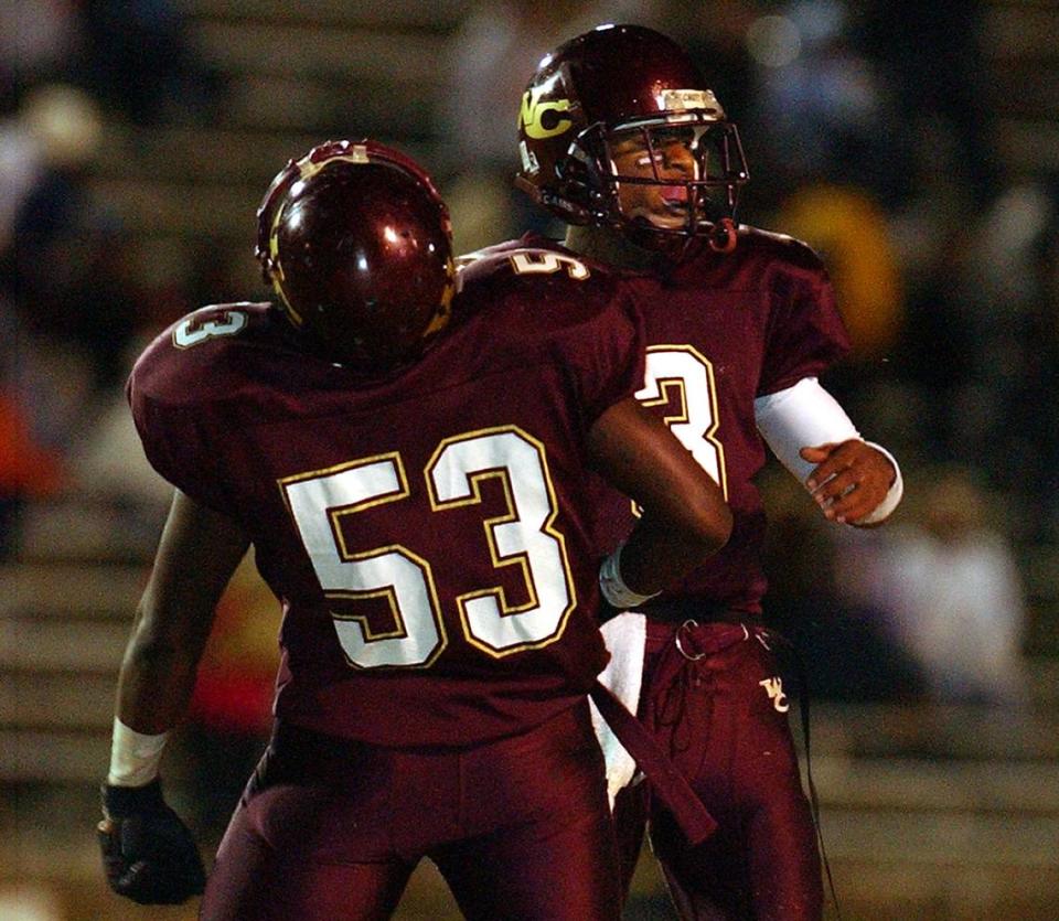 West Charlotte quarterback Darius Thomas (rear) celebrates his rushing touchdown with teammate Chris Houston during the fourth quarter of West Charlotte’s 49-27 win over Richmond County in the state quarterfinal game at Memorial Stadium in Charlotte Friday. Thomas threw for 501 yards on the game. West Charlotte will face Independence next Friday at Memorial Stadium, with the winner playing in the state championship. LOGAN PRICE - loganprice@charlotteobserver.com