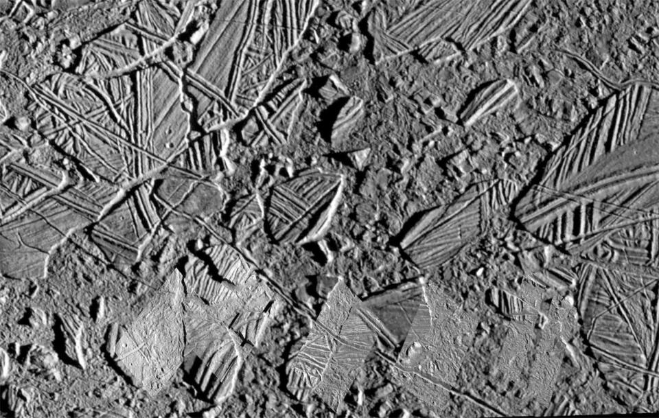 A closeup showing a chaotic jumble of huge, icy slabs making up Europa's frozen surface as imaged by NASA's Galileo spacecraft more than two decades ago. / Credit: NASA