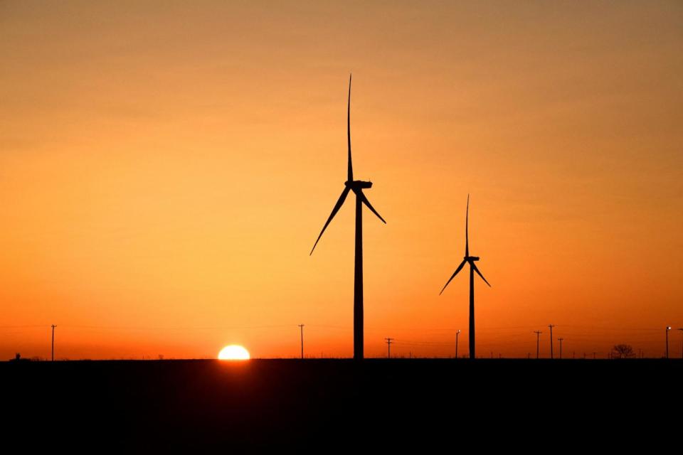 PHOTO: Wind turbines operate at sunrise in the Permian Basin oil and natural gas production area, Feb. 12, 2019, in Big Spring, Texas. (Nick Oxford/Reuters, FILE)