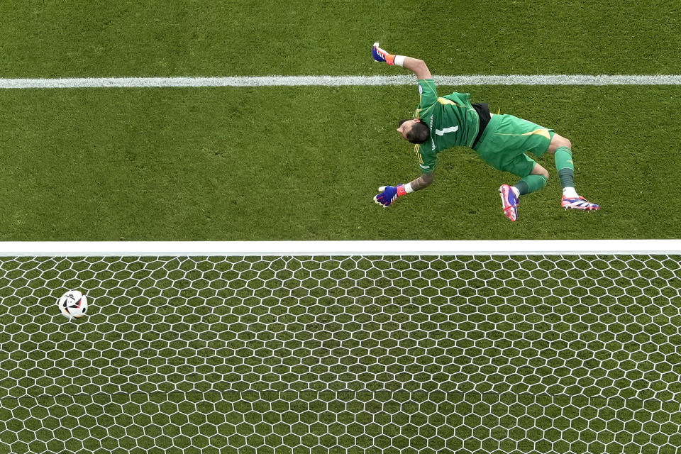 Italy's goalkeeper Gianluigi Donnarumma fails to stop a shot for a goal by Switzerland's Ruben Vargas during a round of sixteen match between Switzerland and Italy at the Euro 2024 soccer tournament in Berlin, Germany, Saturday, June 29, 2024. (AP Photo/Markus Schreiber)