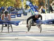 Marcel Hug of Switzerland (R) crosses the finish line ahead of Kurt Fearnley of Australia to win the mens wheelchair division of the 2016 New York City Marathon in Central Park in the Manhattan borough of New York City, New York, U.S. November 6, 2016. REUTERS/Mike Segar