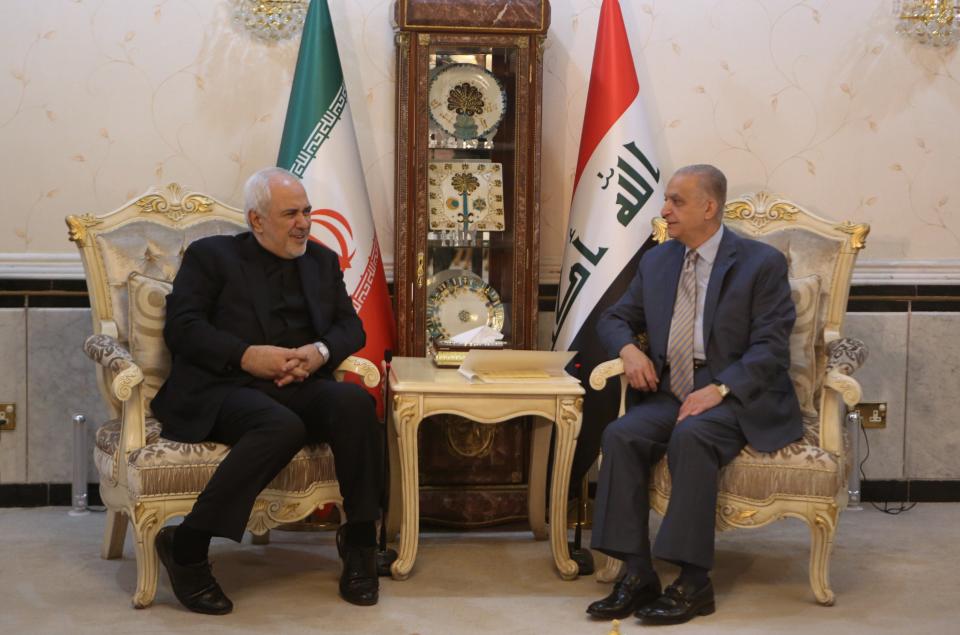 Iraqi Foreign Minister Mohamed Alhahkim, right, meets with his visiting Iranian counterpart Mohammad Javad Zarif at the Ministry of Foreign Affairs in Baghdad, Iraq, Sunday, May 26, 2019. (AP Photo/Khalid Mohammed)