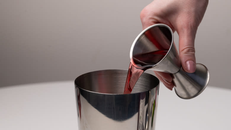 pouring gin into cocktail shake