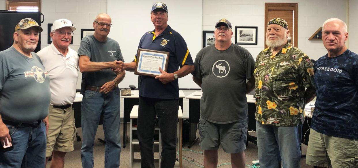 Coast Guard veteran Tom Chastain (center) was recently named Cheboygan County's Hometown Hero for the month of July.