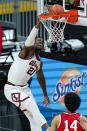 Illinois center Kofi Cockburn (21) goes up for a dunk against Ohio State in an NCAA college basketball championship game at the Big Ten Conference tournament in Indianapolis, Sunday, March 14, 2021. (AP Photo/Michael Conroy)