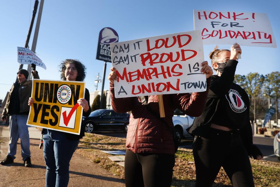 Pro-union demonstrators stand outside of a Starbucks on Poplar Avenue in Memphis, Tenn. where several workers were fired on Tuesday, Feb. 8, 2022. 