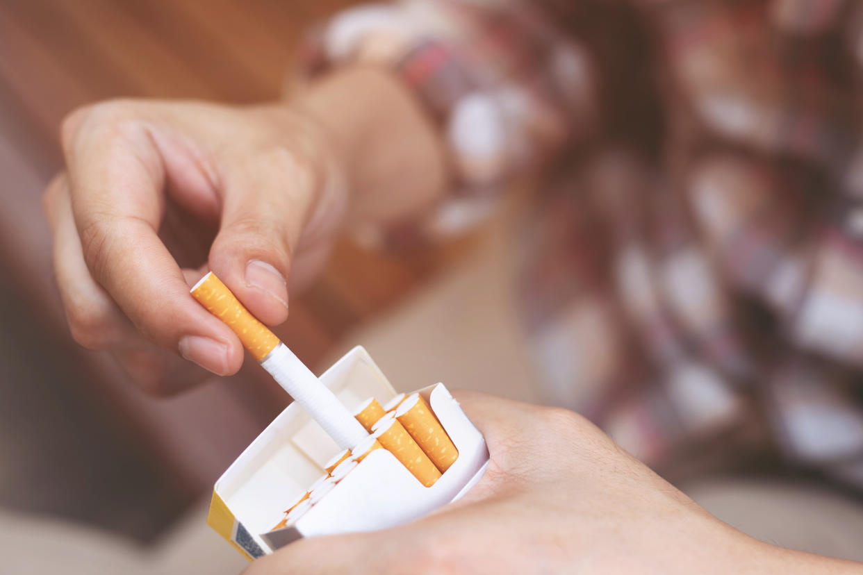 Close-Up Of Person Holding Cigarette Pack