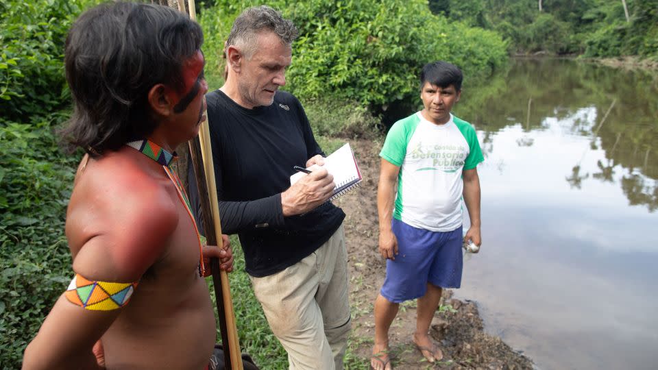Veteran foreign correspondent Dom Phillips talks to two indigenous men in Aldeia Maloca Papiú, in the state of Roraima, Brazil in 2019. Phillips went missing while researching a book in the Brazilian Amazon's Javari Valley and later found dead with respected indigenous expert Bruno Pereira. - Joao Laet/AFP/Getty Images