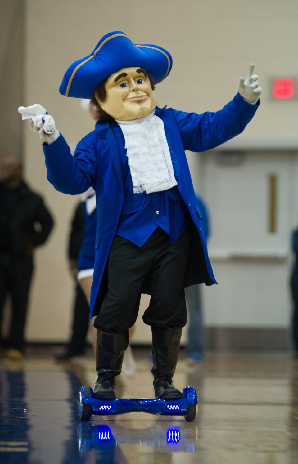 The Dover Senator mascot rides a hoverboard, energizing the crowd in a DIAA tournament basketball game.