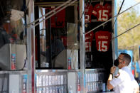 A first responder looks at merchandise from a vendor before Super Bowl LV between the Tampa Bay Buccaneers and the Kansas City Chiefs at Raymond James Stadium on February 07, 2021 in Tampa, Florida. (Photo by Kevin C. Cox/Getty Images)