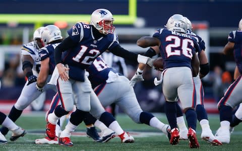 New England Patriots quarterback Tom Brady (12) hands the ball to running back Sony Michel (26) during the second quarter in an AFC Divisional playoff football game at Gillette Stadium - Credit: USA TODAY