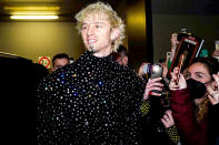 <p>Machine Gun Kelly arrives in style wearing Dolce & Gabbana for Men's Fashion Week in Milan on Jan. 15.</p>