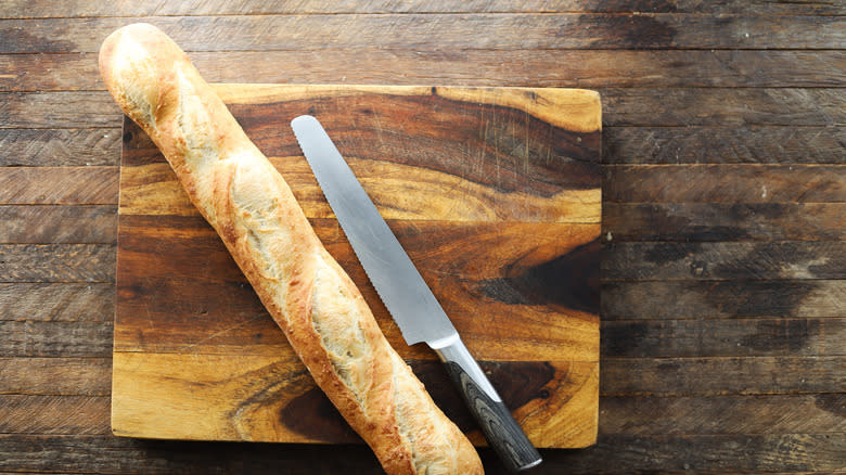 Knife and baguette on board