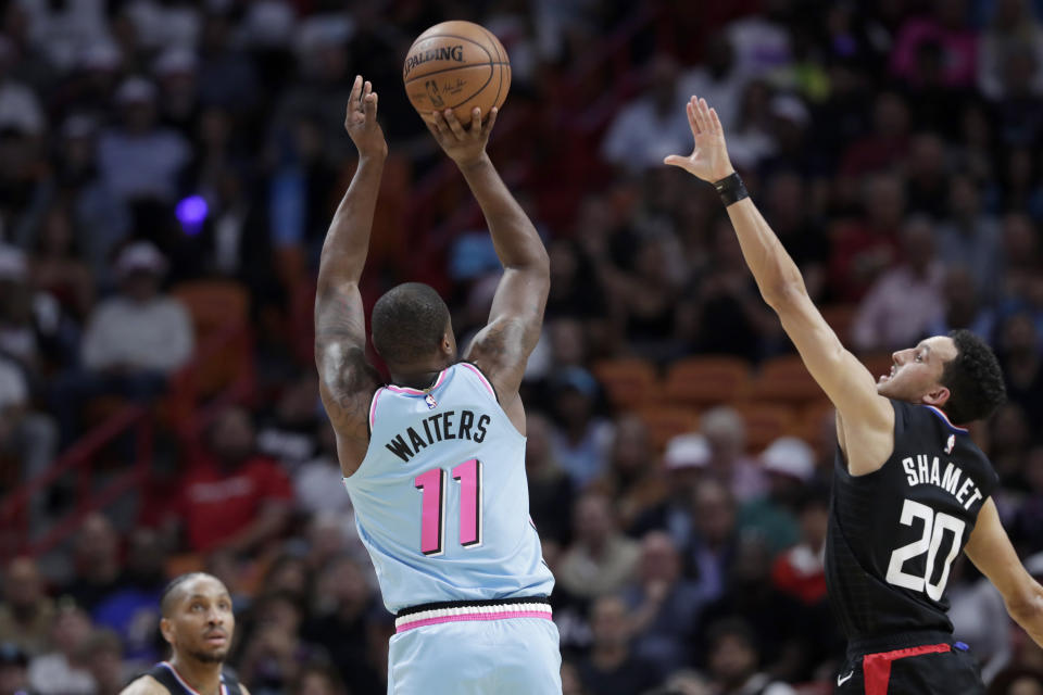 Miami Heat guard Dion Waiters (11) shoots as Los Angeles Clippers guard Landry Shamet (20) defends during the first half of an NBA basketball game, Friday, Jan. 24, 2020, in Miami. (AP Photo/Lynne Sladky)