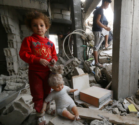 A child stands on the rubble of damaged buildings in Raqqa, Syria October 12, 2018. REUTERS/Aboud Hamam