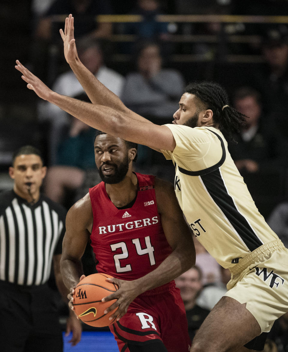 Rutgers' guard Austin Williams (24) looks for a pass while pressured by Wake Forest forward Efton Reid III (4) during the first half of an NCAA college basketball game on Wednesday, Dec. 6, 2023, at Joel Coliseum in Winston-Salem, N.C. (Allison Lee Isley/The Winston-Salem Journal via AP)