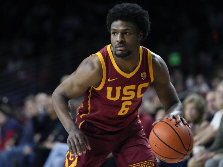 FILE - Southern California guard Bronny James dribbles the ball during the first half of an NCAA college basketball game against UCLA, Saturday, Jan. 27, 2024, in Los Angeles. Bronny James will enter the NBA draft after one season at Southern California that was shortened by his recovery from cardiac arrest. The 19-year-old son of LeBron James announced Friday, April 5, 2024, on his Instagram account that he also plans to retain his college eligibility and will enter the transfer portal.(AP Photo/Ryan Sun, File)