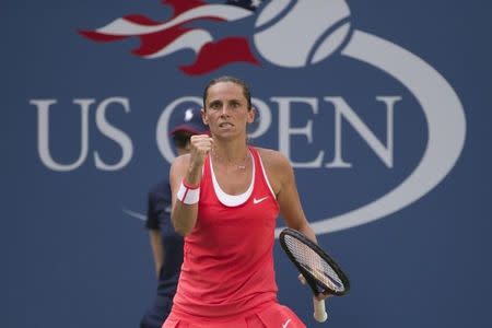 Roberta Vinci of Italy celebrates winning a point against Kristina Mladenovic of France during their quarterfinals match at the U.S. Open Championships tennis tournament in New York, September 8, 2015. REUTERS/Adrees Latif