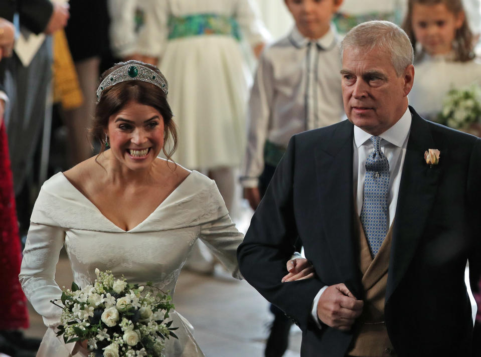 Princess Eugenie walks down the aisle linking her dad, Prince Andrew