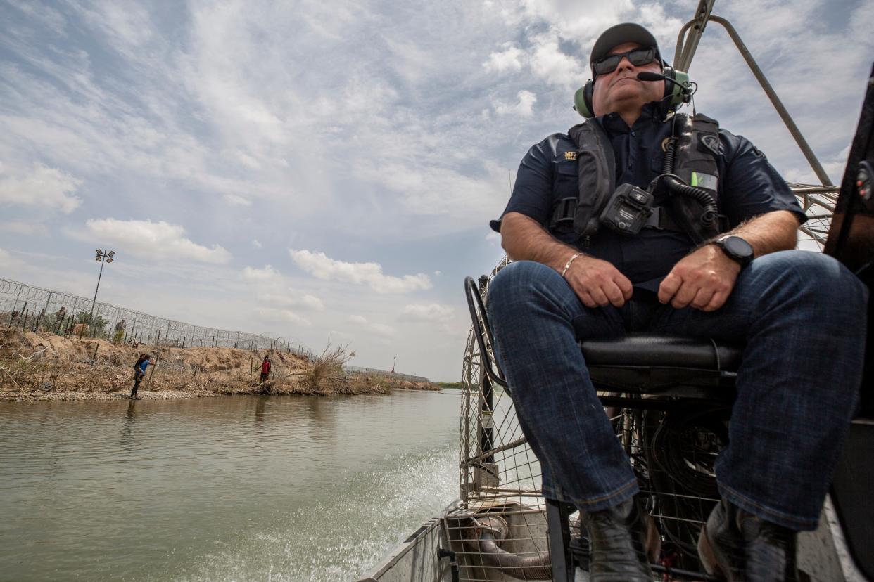Texas Border Czar Mike Banks navigates in the Rio Grande past a group of migrants on the northern bank of the Rio Grande in Eagle Pass, Texas during his visit to Shelby Park in Eagle Pass, Texas on April 16, 2024.