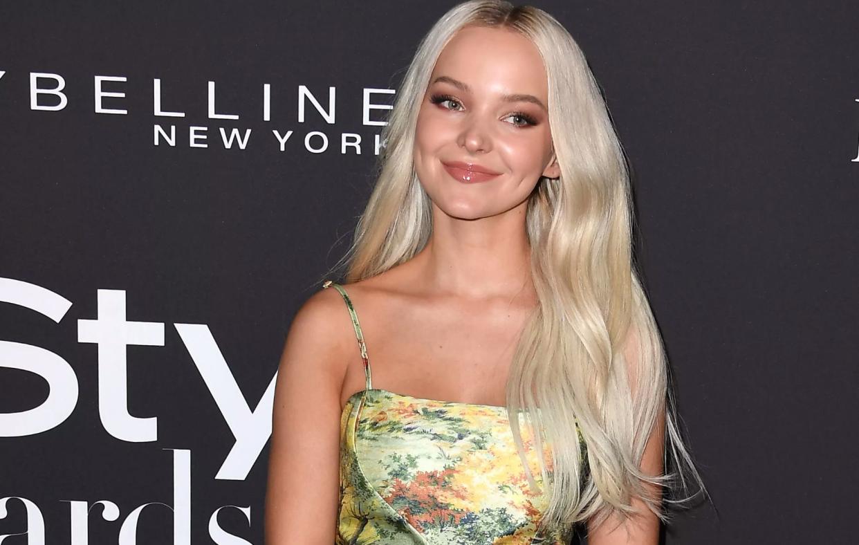 Dove Cameron poses at an event