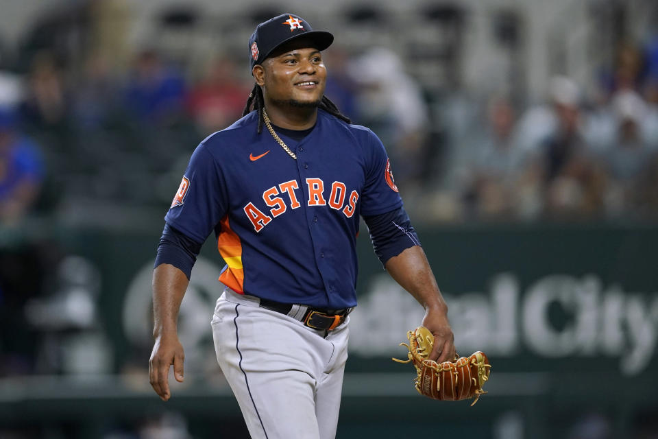 Houston Astros' Framber Valdez smiles as he walks to the dugout after working against the Texas Rangers during the eighth inning of a baseball game in Arlington, Texas, Tuesday, Aug. 30, 2022. (AP Photo/Tony Gutierrez)