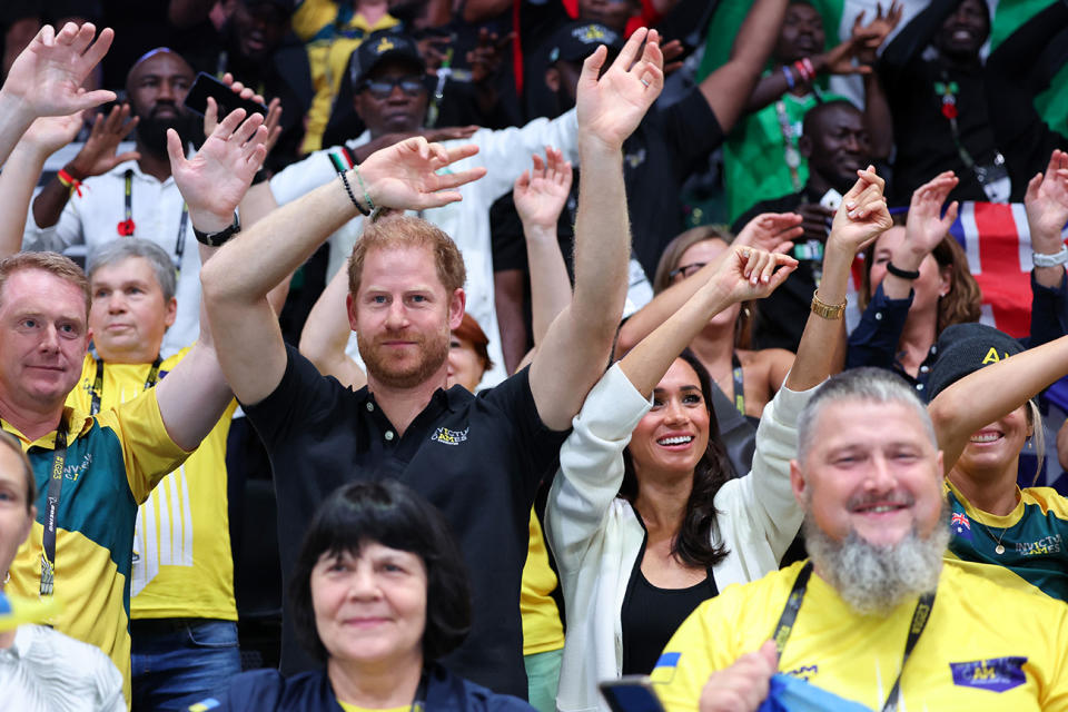 DUESSELDORF, GERMANY - SEPTEMBER 13: Prince Harry, Duke of Sussex and Meghan, Duchess of Sussex wave their hands as they attend the Wheelchair Basketball preliminary match between Ukraine and Australia during day four of the Invictus Games D√ºsseldorf 2023 on September 13, 2023 in Duesseldorf, Germany. (Photo by Chris Jackson/Getty Images for the Invictus Games Foundation)