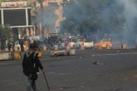 Smoke rise from tear gas fired by security forces during clashes with anti-government protesters in Baghdad, Iraq, Saturday, Jan. 25, 2020. Security forces set fire to anti-government protest tents in the country's south early Saturday and re-opened key public squares in Baghdad that had been occupied by demonstrators for months. (AP Photo/Hadi Mizban)