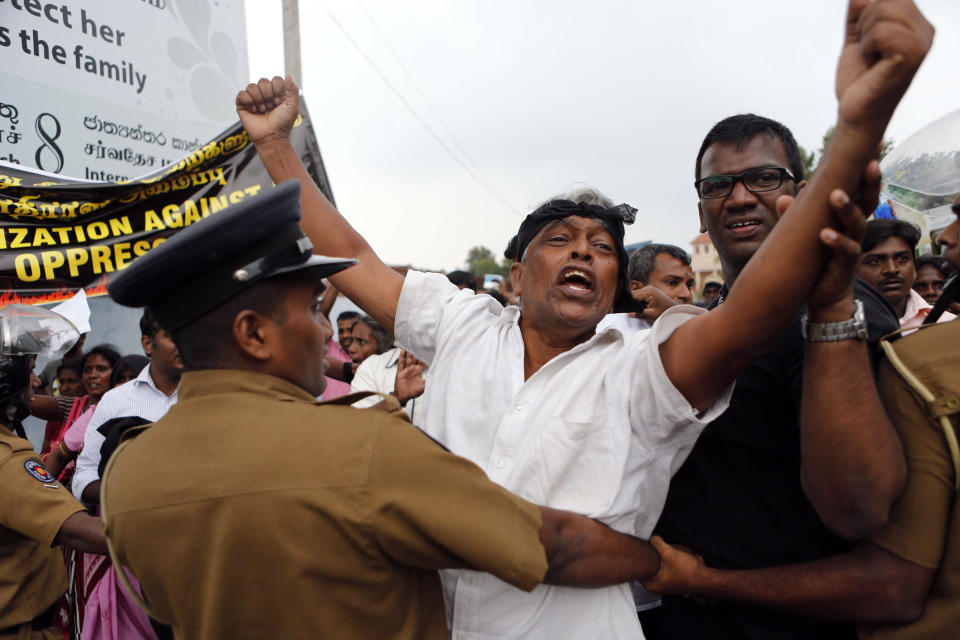 FILE - In this Nov. 15, 2013, file photo, Sri Lankan human rights activists shout slogans, demanding an international enquiry on human rights abuse in the country in Jaffna, northern Sri Lanka. Worries about Islamic extremism will be paramount for many Sri Lankan voters while others hope to block former leaders accused of human rights violations from returning to power in Saturday’s presidential election, the country’s first national polls since last Easter’s deadly suicide attacks. (AP Photo/Eranga Jayawardena, File)