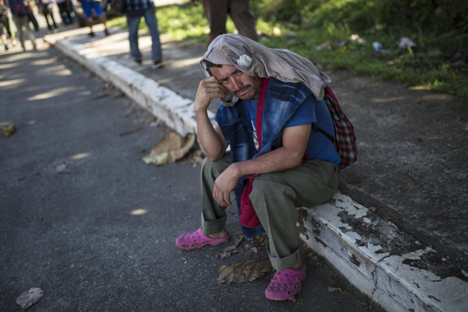 Honduran migrant Geovany Pajuense takes a break from walking to Tapachula from Ciudad Hidalgo, Mexico, Tuesday, Oct. 30, 2018. He is part of a second caravan of more than 1,000 that forced its way across the river from Guatemala on Monday. Some have begun arriving in the southern Mexico city of Tapachula. (AP Photo/Rodrigo Abd)