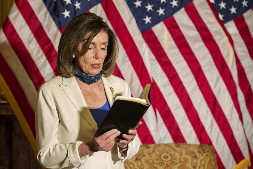 House Speaker Nancy Pelosi of Calif., reads from the Bible, as she reacts to President Donald Trump during a news conference at the U.S. Capitol in Washington, Tuesday, June 2, 2020. (AP Photo/Manuel Balce Ceneta)