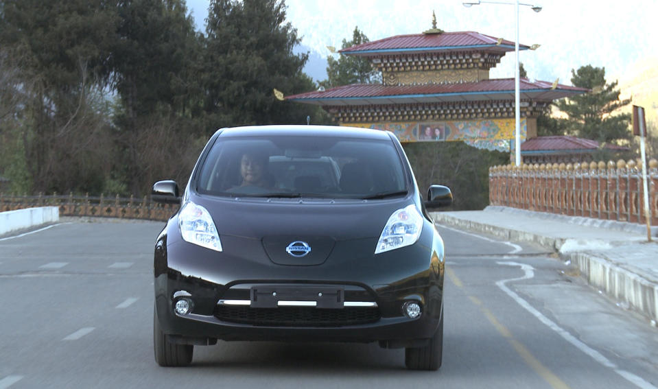 In this undated photo released Friday, Feb. 21, 2014 by Nissan Motor Co., the Japanese automaker's electric car Leaf runs in Thimphu in Bhutan. The Himalayan kingdom of Bhutan and Nissan are partnering on electric cars, with the Japanese automaker's Leaf being chosen for the government fleet and taxis. Under a deal announced Friday, Feb. 21, 2014, Nissan will help Bhutan achieve its goal of becoming a zero-emissions nation. (AP Photo/Nissan Motor Co.)