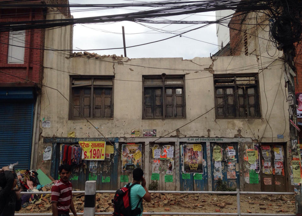 People walk past damage in Kathmandu, April 25, 2015.  (AP Photo/ Niranjan Shrestha)