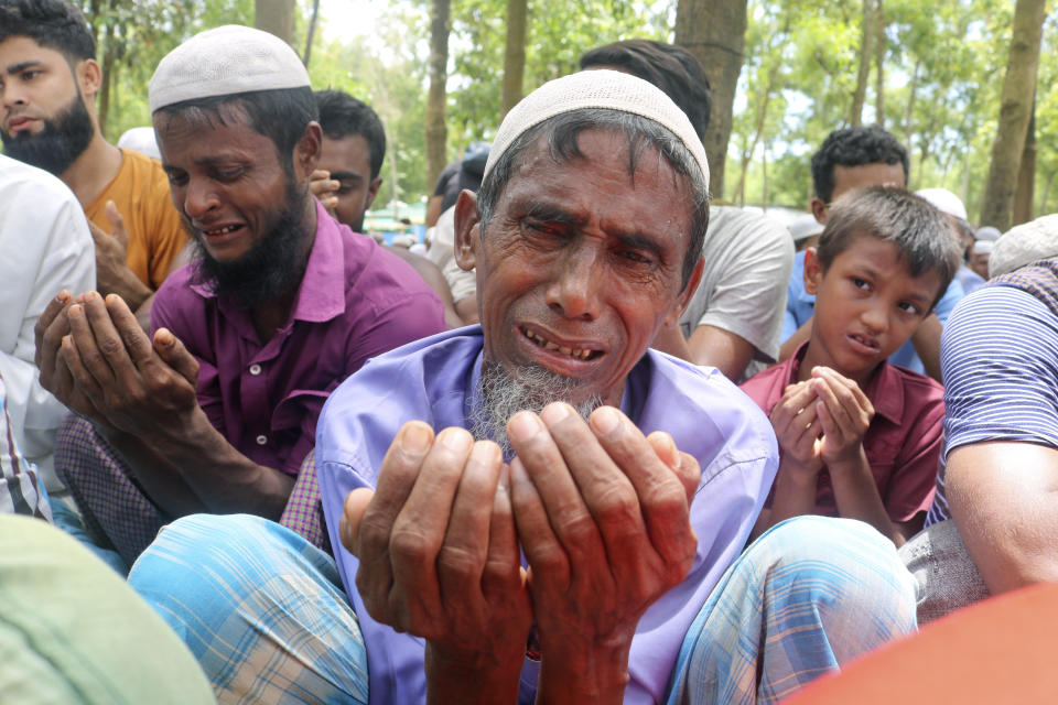 Rohingya refugees cry while praying during a gathering to mark the fifth anniversary of their exodus from Myanmar to Bangladesh, at a Kutupalong Rohingya refugee camp at Ukhiya in Cox's Bazar district, Bangladesh, Thursday, Aug. 25, 2022. Hundreds of thousands of Rohingya refugees on Thursday marked the fifth anniversary of their exodus from Myanmar to Bangladesh, while the United States, European Union and other Western nations pledged to continue supporting the refugees' pursuit of justice in international courts.(AP Photo/ Shafiqur Rahman)