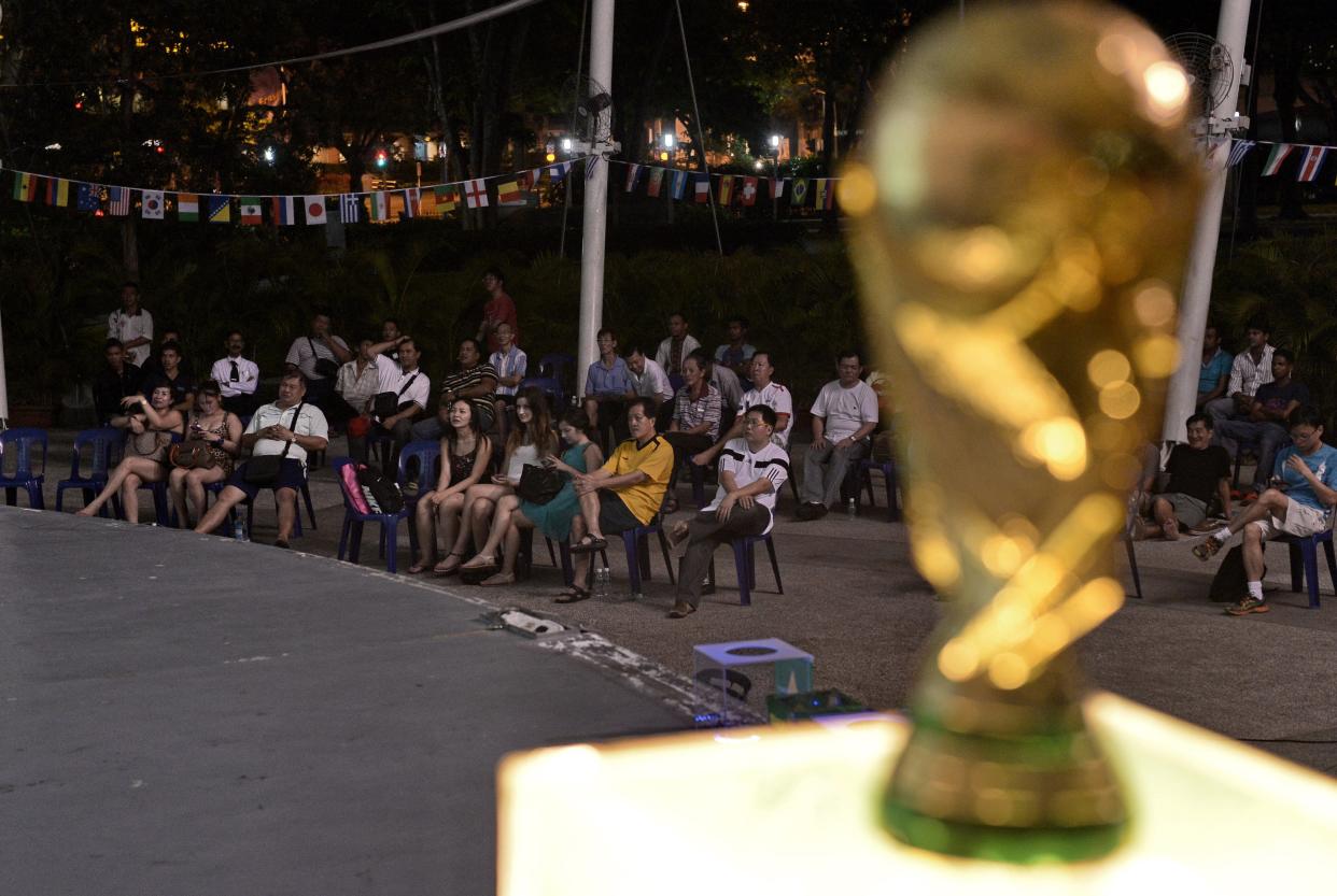 Singapore residents watching the live telecast of a FIFA World Cup match. 