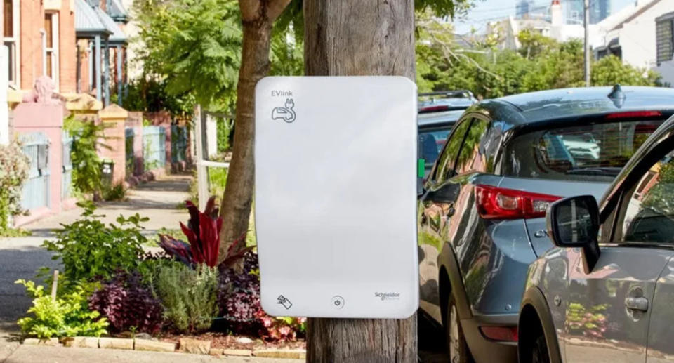 The white electric car charger on power pole.